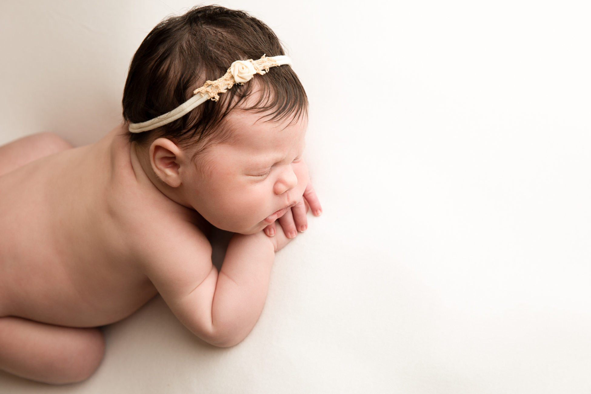 baby photographed in forward facing pose from above